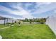 Expansive backyard features lush green grass and a white picket fence at 533 Vista Ridge Dr, Ruskin, FL 33570