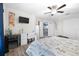 Bright bedroom with ceiling fan, a TV, and a desk alongside a view into another room at 533 Vista Ridge Dr, Ruskin, FL 33570