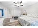 Bright bedroom features a ceiling fan, white walls and closet, and decorative floral quilt at 533 Vista Ridge Dr, Ruskin, FL 33570