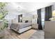 Beautifully decorated primary bedroom with a tufted headboard, decorative lighting, and stylish furnishings at 533 Vista Ridge Dr, Ruskin, FL 33570