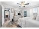 Airy bedroom with wood floors, a comfortable bed, and a view into an adjoining living area at 533 Vista Ridge Dr, Ruskin, FL 33570