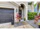 Inviting front entrance showcasing a dark grey garage door and landscaped walkway to the front door at 533 Vista Ridge Dr, Ruskin, FL 33570