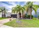Charming two-story home with a well-maintained lawn and landscaping featuring palm trees and flowering plants at 533 Vista Ridge Dr, Ruskin, FL 33570