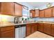 Kitchen with granite countertops, stainless steel dishwasher, and ample wooden cabinet storage at 533 Vista Ridge Dr, Ruskin, FL 33570