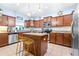The kitchen features stainless steel appliances, granite countertops, and an island with bar seating at 533 Vista Ridge Dr, Ruskin, FL 33570