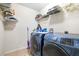 Practical laundry room features modern washer and dryer, plus storage shelves for supplies at 533 Vista Ridge Dr, Ruskin, FL 33570