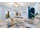 Inviting living room featuring a plush sofa, glass coffee table, and staircase access at 533 Vista Ridge Dr, Ruskin, FL 33570