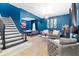 Stylish living room featuring blue walls, tile flooring, and modern decor with a staircase view at 533 Vista Ridge Dr, Ruskin, FL 33570