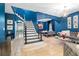 Stylish living room featuring blue walls, tile flooring, and modern decor with a staircase view at 533 Vista Ridge Dr, Ruskin, FL 33570