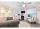 Cozy living room features a comfy gray sofa, a plush rug, and a well-lit workstation at 533 Vista Ridge Dr, Ruskin, FL 33570
