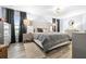 Serene main bedroom with a tufted headboard, gray bedding, and wood-look floors at 533 Vista Ridge Dr, Ruskin, FL 33570