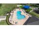 Aerial view of the community pool showcasing lounge seating, landscaping and a playground at 533 Vista Ridge Dr, Ruskin, FL 33570