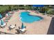 Overhead shot of a clover-shaped pool with ample lounge seating and tables with umbrellas at 533 Vista Ridge Dr, Ruskin, FL 33570