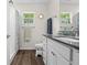 Bathroom featuring granite countertop, framed mirror, and a window providing natural light at 5422 Wilkins Trl, Brooksville, FL 34602