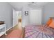 Cozy bedroom with hardwood floors, double door closet, and a view leading into a separate dining room space at 5422 Wilkins Trl, Brooksville, FL 34602