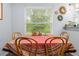 Charming dining area with wood table, window view, and decorative wall art at 5422 Wilkins Trl, Brooksville, FL 34602