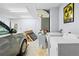 A well-lit garage includes laundry machines, a car, storage items and a fun fallout shelter poster on the wall at 5422 Wilkins Trl, Brooksville, FL 34602