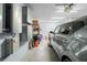 A well-organized garage with shelving, a parked car, and an energy storage system mounted on the wall at 5422 Wilkins Trl, Brooksville, FL 34602