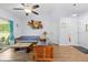 Comfortable living room with rustic wood furniture, ceiling fan, and bright natural light at 5422 Wilkins Trl, Brooksville, FL 34602