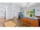 Open-concept living room with wood-look floors, vaulted ceiling, and sliding glass doors to the patio at 5422 Wilkins Trl, Brooksville, FL 34602