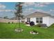 Spacious backyard with lush green lawn, mature landscaping, and ample room for outdoor activities at 5687 Barakat Rd, Zephyrhills, FL 33541