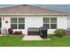 Well-maintained backyard with a seating area and grill, perfect for outdoor entertaining and relaxation at 5687 Barakat Rd, Zephyrhills, FL 33541
