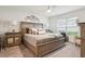 Spacious bedroom featuring neutral tones, a padded headboard, side tables and a comfortably made bed at 5687 Barakat Rd, Zephyrhills, FL 33541