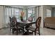 Formal dining room with a large wooden table, six chairs and natural light at 5687 Barakat Rd, Zephyrhills, FL 33541
