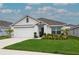 Charming single-story home featuring a well-manicured lawn, two car garage, and inviting entrance at 5687 Barakat Rd, Zephyrhills, FL 33541