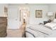 View into the hallway connecting a bedroom with soft carpet and art on the wall to the en suite bathroom at 5687 Barakat Rd, Zephyrhills, FL 33541