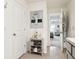 A light and bright hallway connects the bedroom to the bathroom and features a towel rack at 5687 Barakat Rd, Zephyrhills, FL 33541