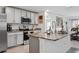 Well-lit kitchen with stainless steel appliances, granite counters and ample cabinet space at 5687 Barakat Rd, Zephyrhills, FL 33541