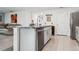 Bright kitchen island featuring stainless steel appliances and eat in bar at 5687 Barakat Rd, Zephyrhills, FL 33541
