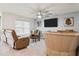Inviting living room featuring comfortable seating and a large ceiling fan at 5687 Barakat Rd, Zephyrhills, FL 33541