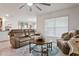 Comfortable living room featuring a ceiling fan, tile floors, and large windows at 5687 Barakat Rd, Zephyrhills, FL 33541