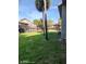 A view of the lawn area behind some of the condominiums, shaded by mature trees and green grass at 6306 Newtown Cir # 6A3, Tampa, FL 33615