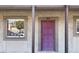 A ground floor condominium entrance with a purple door, a window, and the unit number marked above the door at 6306 Newtown Cir # 6A3, Tampa, FL 33615