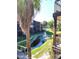 A community pond with a fountain surrounded by lawns and condominiums, viewed from a condominium deck at 6306 Newtown Cir # 6A3, Tampa, FL 33615