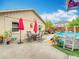 Inviting backyard with a pool, outdoor dining set, and well-kept landscaping provides space for relaxing and entertaining at 6425 S Adelia Ave, Tampa, FL 33616