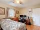 Bedroom features wood floors, a ceiling fan and a window to allow natural light at 6425 S Adelia Ave, Tampa, FL 33616