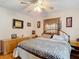 Bedroom features wood floors, a ceiling fan, and ample natural light at 6425 S Adelia Ave, Tampa, FL 33616