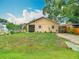 Well-manicured front yard with lush green grass and landscaping surrounding a cozy home at 6425 S Adelia Ave, Tampa, FL 33616