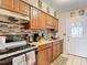 Efficient kitchen features stylish cabinets, backsplash, and modern appliances for a seamless cooking experience at 6425 S Adelia Ave, Tampa, FL 33616