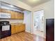 A kitchen with light wood cabinets, black appliances, and wood flooring at 6425 S Adelia Ave, Tampa, FL 33616