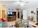 Inviting living room features tile flooring, a large TV, and easy access to the kitchen and other areas at 6425 S Adelia Ave, Tampa, FL 33616