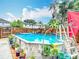 Above-ground pool is surrounded by lush landscaping, creating a private and refreshing backyard oasis at 6425 S Adelia Ave, Tampa, FL 33616