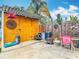 Backyard shed with unique decor and accessories, sitting near an outdoor grill and seating area at 6425 S Adelia Ave, Tampa, FL 33616