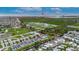 Aerial view of community, showing canal access to the ocean, nearby green spaces, and city views at 6528 Simone Shores Cir, Apollo Beach, FL 33572