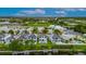 Expansive aerial view of waterfront homes, showcasing lush greenery, a private dock, and waterway access at 6528 Simone Shores Cir, Apollo Beach, FL 33572