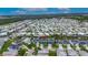 Extensive aerial view of neighborhood with houses along canals and waterways under a cloudy sky at 6528 Simone Shores Cir, Apollo Beach, FL 33572